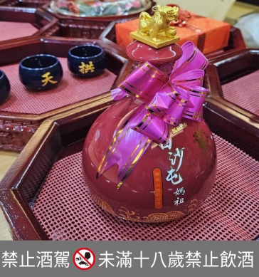 白沙屯拱天宮聖母登轎大典,「馬祖高粱白沙屯有求必應紀念酒」成為祈福供品。(照片泰山提供)